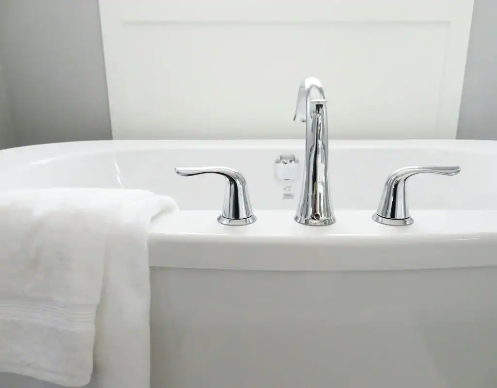 Polished bathtub with chrome fixtures, clean and ready for use, professional cleaning service NYC, Bath cleaning experts.