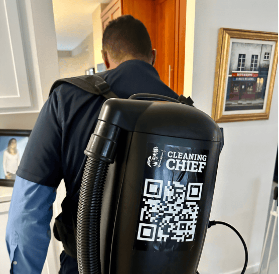 Cleaner using a heavy-duty vacuum to remove dust and debris during post-construction cleaning in a NYC property.