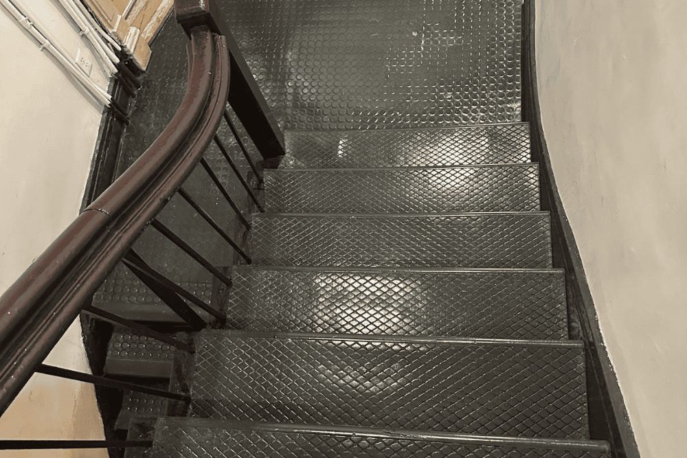 Shiny polished rubber staircase flooring after professional buffing and waxing