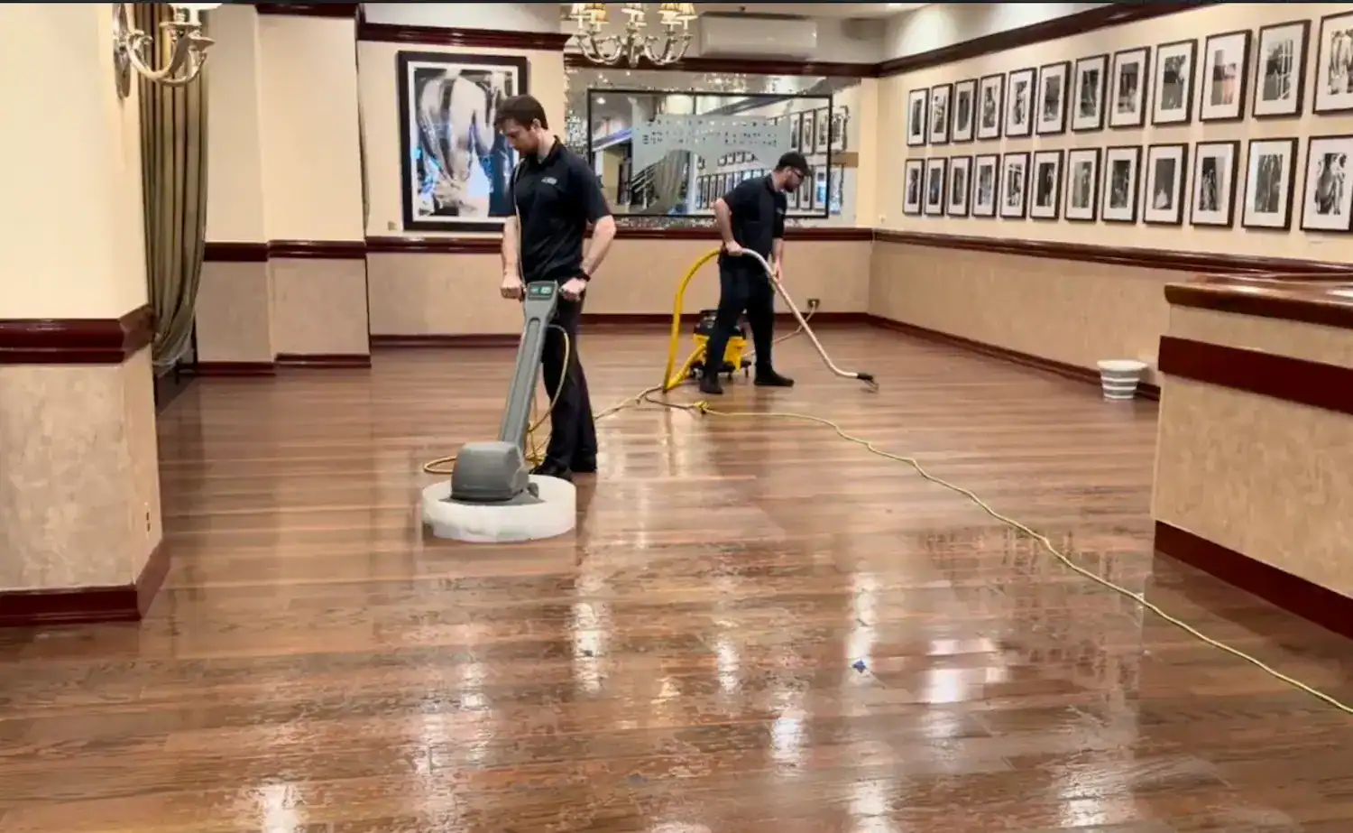 Polished hardwood floor cleaning with professional steam and extraction methods in an elegant hotel corridor.